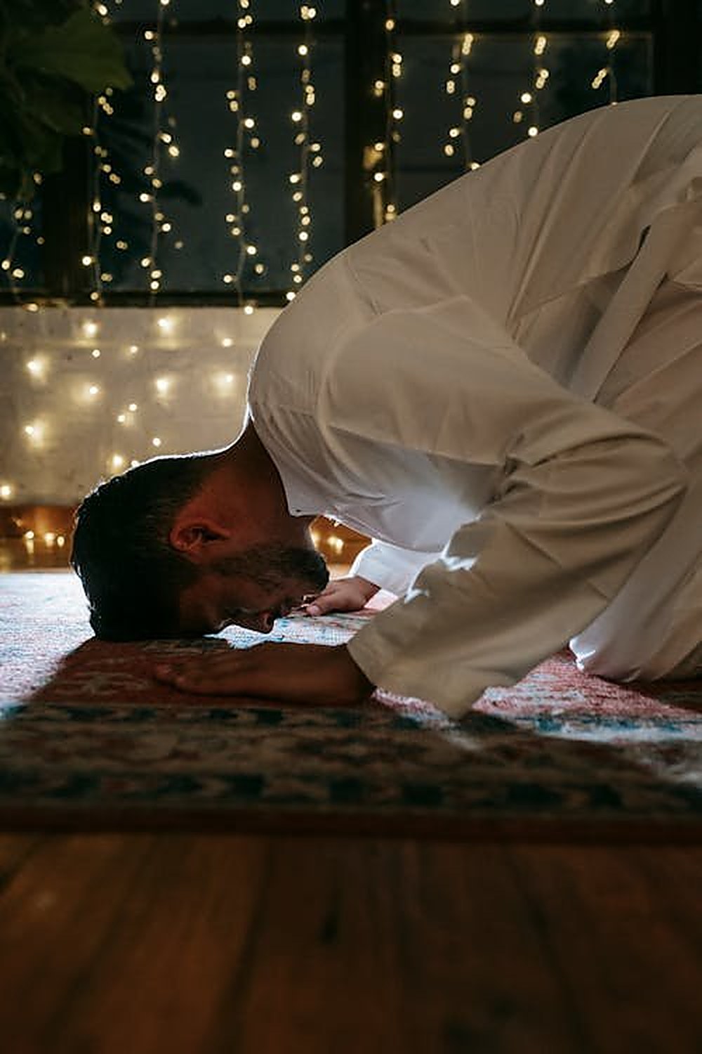 A man in quiet prayer, reflecting the spiritual grounding central to faith-integrated counseling
